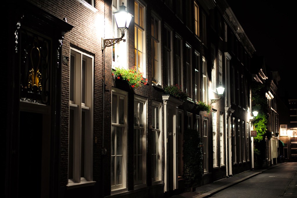 A dark street lit only by old lamps at night