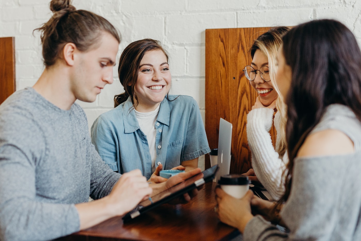 A group of people laughing together at a table